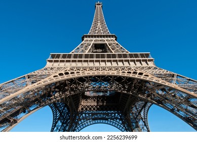 The iconic Eiffel Tower soars into a blue Paris sky.