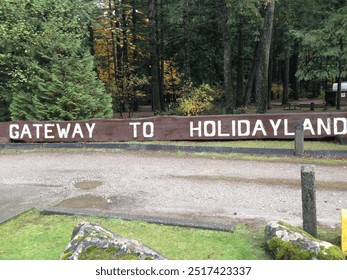 Iconic 'Gateway to Holidayland' sign in Hope, British Columbia, famous as a filming location for the movie Rambo, with scenic surroundings