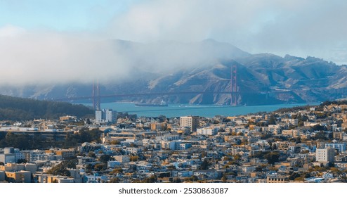 The iconic Golden Gate Bridge towers rise through fog, with Marin County hills in the background and San Francisco's urban landscape in the foreground. - Powered by Shutterstock