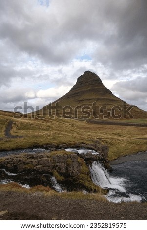 The iconic Icelandic mountain Kirkjufell with waterfalls in foreground
