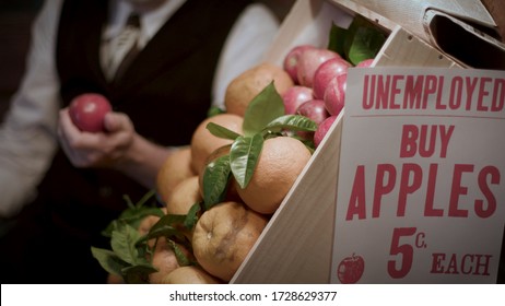 An Iconic Image From The 1930s Great Depression Era Of A Well Dressed Unemployed Man Peddling Apples On The Street In An Effort Make A Little Money To Help Feed His Family.