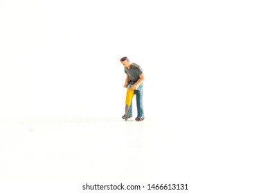 Iconic Image Of A Miniature Construction Worker Using A Jack Hammer/Drill