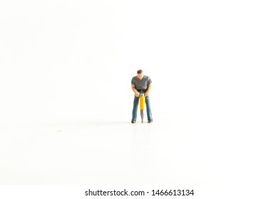 Iconic Image Of A Miniature Construction Worker Using A Jack Hammer/Drill