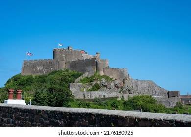 The Iconic Mont Orgueil Castle Guarding The Entrance To Gorey Harbour Of The British Crown Dependency Of Jersey, Channel Islands, British Isles.