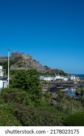 The Iconic Mont Orgueil Castle Guarding The Entrance To Gorey Harbour Of The British Crown Dependency Of Jersey, Channel Islands, British Isles.