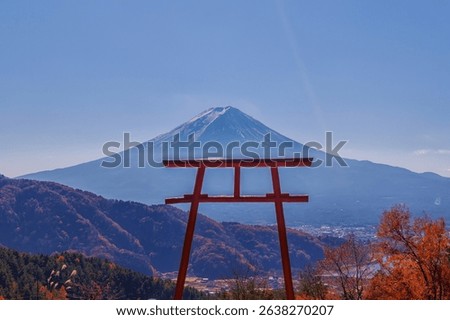 Iconic red torii gate frames majestic Mount Fuji in Japan.