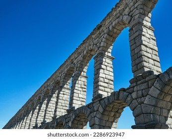 The iconic Roman Aqueduct of Segovia, an architectural marvel that has stood the test of time since the early 2nd century AD. The precision and grandeur of this ancient engineering feat is beautifully - Powered by Shutterstock