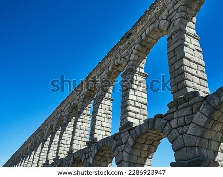 The iconic Roman Aqueduct of Segovia, an architectural marvel that has stood the test of time since the early 2nd century AD. The precision and grandeur of this ancient engineering feat is beautifully
