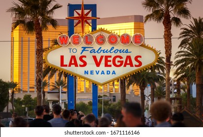 Iconic Sign Welcome to Fabulous Las Vegas in Nevada crowded by people waiting in a long line to pose with the sign and take a photo