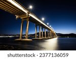 The iconic Tasman Bridge at dusk on a clear spring evening crossing the Derwent RIver in central Hobart, Tasmania, Australia. Shot from the Clarence foreshore