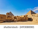 An Iconic view of the Great Pyramids of Khufu, Khafre and the Sphinx, magnificent testimony to the glory of ancient egypt on a bright day on the Giza plateau near Cairo,Egypt