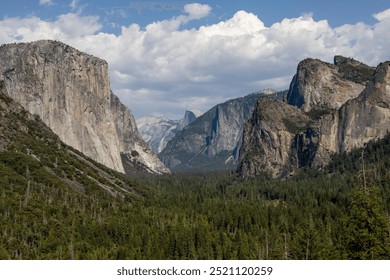 Iconic vista of Yosemite Valley from Tunnel View, showcasing El Capitan, Half Dome, and Bridalveil Fall amidst a sea of evergreens under a dramatic cloudscape in Yosemite National Park, California. - Powered by Shutterstock