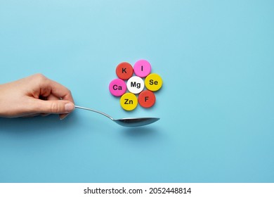 Icons of minerals and macronutrients on a spoon. The choice of food with a high content of vitamins and trace elements - Shutterstock ID 2052448814