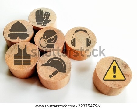 Icons of safety at workplace and attention symbol on wooden blocks isolated white background.Concept of workplace safety Or Safety at work.