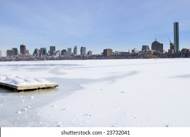 Icy charles river overlooking boston skyline in the winter