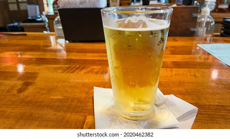 An Icy  Cold Draft Beer In A Glass Sitting On A Bar In Florida.