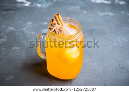 Icy cold mandarin beverage on the rustic background. Selective focus. Shallow depth of field.