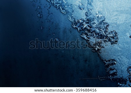 icy pattern on dark winter frosted window/icy pattern on dark winter frosted window/ frozen background