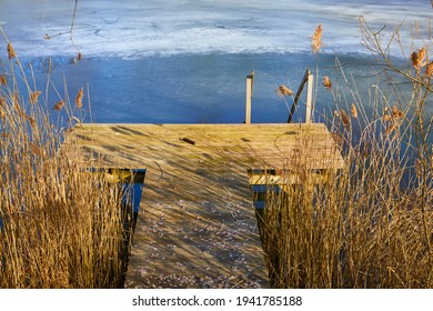 Icy Pond With A Wooden Walkway