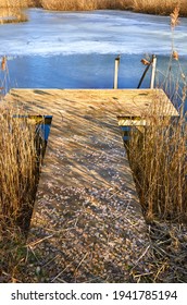 Icy Pond With A Wooden Walkway