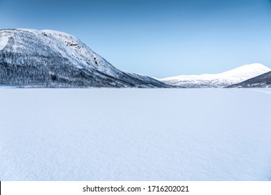 Icy Road Against Snowcapped Mountain