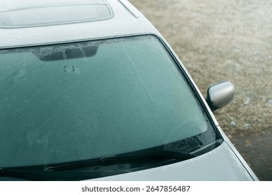 Icy windshield making driving difficult in snow