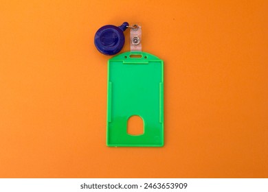 “Professional ID Badge Holder”: A sturdy green plastic name tag holder with an oval opening for easy card access. Ideal for conferences, offices, and events. - Powered by Shutterstock