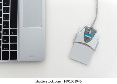 ID Card Reader Digital Technology On White Table With Part Of Laptop