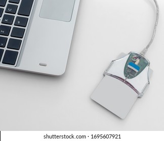 ID Card Reader Digital Technology On White Table In The Office With Part Of Laptop Keyboard