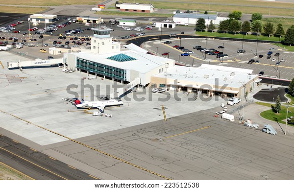 Idaho Falls, Idaho, USA Aug. 16, 2014 An aerial\
view of an airport terminal in a mid sized American city.  It\
depicts long and short term parking, car rental, taxiway, jet ways,\
and terminal building.