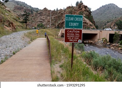 Idaho Springs, CO, USA - August 8, 2018: Entering Clear Creek county along the Scott Lancaster Memorial Trail. Caution sign upon entering Clear Creek county from Jefferson county on a trail.