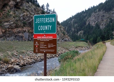 Idaho Springs, CO, USA - August 8, 2018: Scott Lancaster Memorial Trail park regulations sign along Clear Creek. Small outdoor sign in Jefferson county along Clear Creek showing rules of the park.