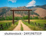 Idaho Summer Road Travel Landscape along the Salmon River Scenic Byway U.S. Route 93: The Beautiful Western Rocky Mountains with Wooden Ranch Gate