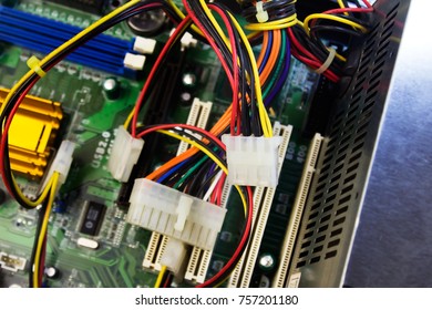 IDE power computer cables laying disconnected on motherboard background.