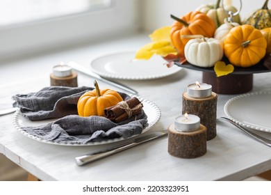 Idea For A Beautiful Autumn Setting For Thanksgiving Family Dinner Or Wedding. Orange Pumpkin As Decor. Cozy Fall Home Atmosphere.