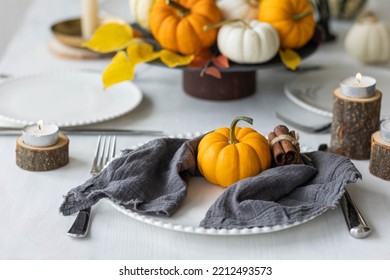 Idea For A Beautiful Autumn Setting For Thanksgiving Family Dinner Or Wedding. Orange Pumpkin As Decor. Cozy Fall Home Atmosphere.