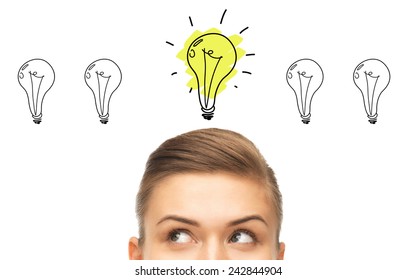 idea, business, education and people concept - close up of beautiful female eyes looking up to lighting bulb doodles