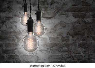 Idea concept -  incandescent bulb on wall background