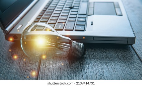 idea concept, light bulb with computer on table