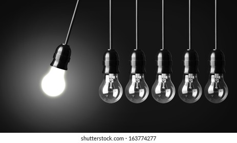 Idea Concept On Black. Perpetual Motion With Light Bulbs