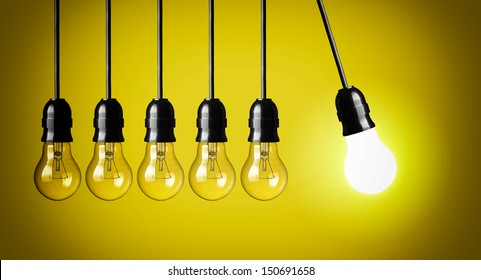 Idea Concept On Yellow Background. Perpetual Motion With Light Bulbs