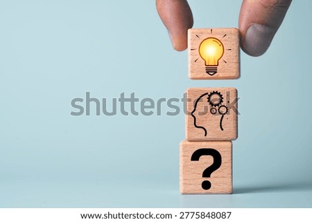 Idea development concept showing question mark, thinking process, and light bulb icon on wooden blocks, represent problem solving, innovation, critical thinking, creativity business solution strategy