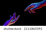 Idea of earth creation. Hands reaching out, pointing finger together on black and neon colorful light. Man and woman, love, religion. Contemporary art, evolution, origins concept.