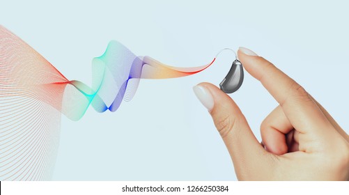 Idea Of Feeling The Fullness Of Hearing. The Hearing Aid Of New Generation Showing Colored Sound Waves. Feel The Whole Palette Of Sounds