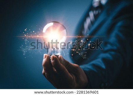 Idea innovation and inspiration concept. Hand of man holding illuminated light bulb, concept creativity with bulbs that shine glitter. Inspiration of ideas for sustainable business development.network