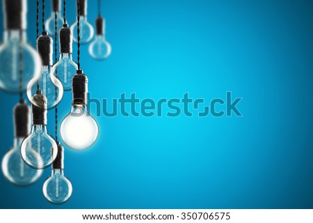 Idea and leadership concept Vintage incandescent Edison type bulbs on color wall