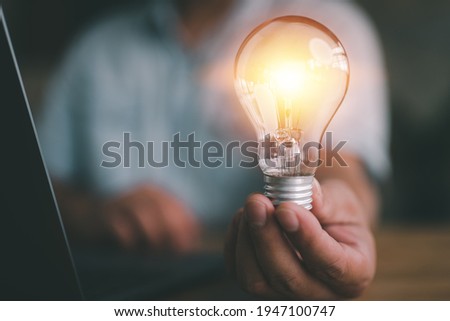 idea and light bulbs concept, businessman show new ideas with innovative technology and creativity.