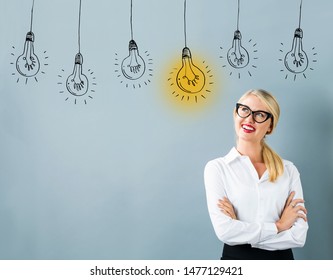 Idea light bulbs with young woman in a thoughtful face