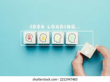 Idea loading concept. Thinking innovation and creativity process and problem solving solution business technology. Hand putting cube block with light bulb icon.