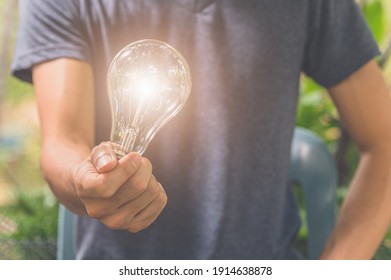 Idea Of A Man Holding A Light Bulb